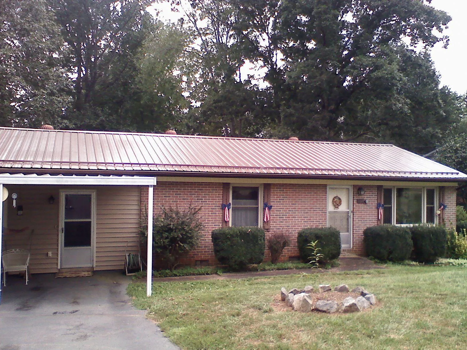 Bronze metal roof and carport on a brick ranch home — Roof Repair work by our crew in Bernalillo